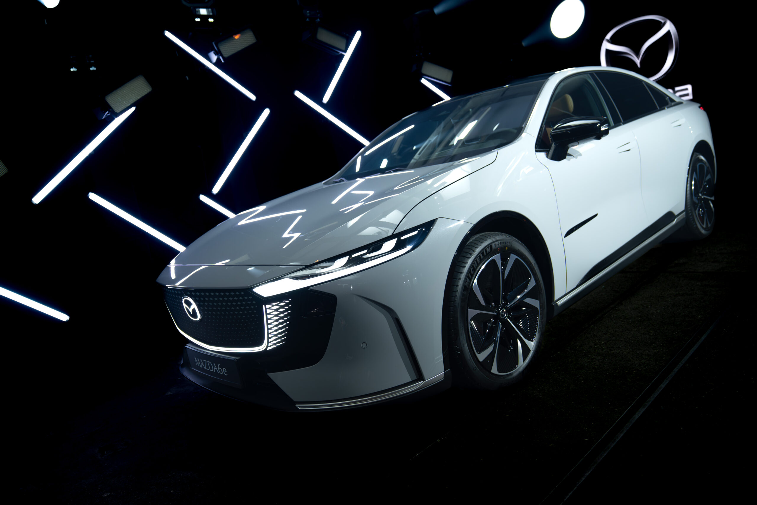 Mazda 6E displayed in a cinematic lighting environment with geometric light elements during the Mazda – Cinematic reveal of the Mazda 6E.